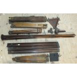 Seven vintage wooden folding tripods.