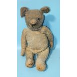 A post-WWI American stick teddy bear with one glass eye, re-stitched nose, blonde mohair plush,