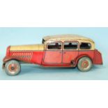 A Mettoy tinplate c/w limousine with cream and red body and 'Dunlop 90' balloon tyres, 27cm long, (