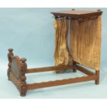 A doll's mahogany half-tester bed with turned pillars and serpentine foot board, 48cm high, 54.5cm
