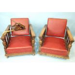 A pair of 1930's oak deep-seated armchairs with adjustable backs, on later castors, one with