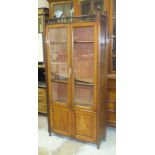 An Edwardian walnut bookcase, the finialled galleried top above a pair of panelled and three-quarter