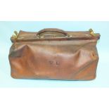 An early-20th century leather Gladstone bag stamped J T Needs, 100 New Bond Street, Late J Bramah,
