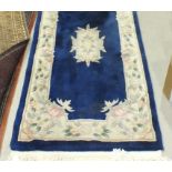 A modern Chinese runner with ivory border and blue ground, 320 x 77cm, a modern Pakistan-made