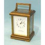 A modern brass carriage clock with bell-striking movement, the case with reeded pillars, enclosing a