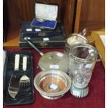 A baby's silver feeding spoon, a plated coaster and other plated ware.