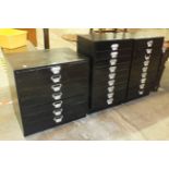 A pair of black-painted wooden chests fitted with nine shallow drawers, 47cm wide, 81cm high and a