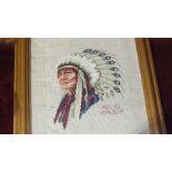 A framed cross-stitch wool-work picture of a Red Indian chief 'Hollow Horn Bear', 34 x 29cm, an