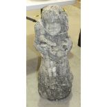 A granite garden statue of a young girl holding a doll, 84.5cm high, indistinctly-signed and dated
