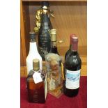 A bottle of Cointreau, Crème De Cassis De Dijon, 70cl, 16% vol. and other bottles.