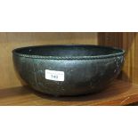 A Hugh Wallis Arts & Crafts copper bowl with rope-twist rim and planished body, on four bun feet,