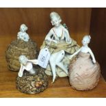 A collection of twenty-eight ceramic lady pin cushions/tea cosy holders.