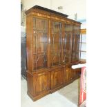 A reproduction Georgian-style mahogany breakfront library bookcase, the moulded cornice above four