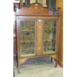 A mahogany display cabinet in the Art Nouveau taste, with stylised inlaid pattern of boxwood and