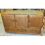 An Ercol ash 'Windsor' sideboard, the rectangular top above three cupboard doors and two drawers, on