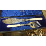 A cased set of plated fish servers, other plated cutlery, a decorated ceramic egg, 7cm high and