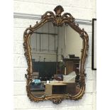 A shaped mirror with gilt frame, 85 x 58cm.