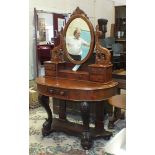 A late-Victorian mahogany duchess-style dressing table, the mirrored superstructure above a bowed