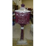 A reproduction Victorian-style painted cast metal floor-standing letterbox, with crown finial and