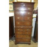 A reproduction mahogany chest of nine drawers, with brushing slide, 64 x 157cm and a mahogany oval-