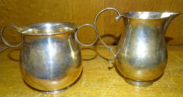 A plain silver baluster two-handled sugar bowl, 8cm high, Chester 1935 and a similar cream jug, 10cm