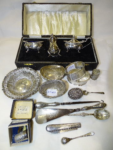 A silver three-piece condiment set with blue glass liners, in case, Sheffield 1977, a pair of