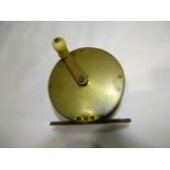 A brass 3¾'' crank-handle brass fishing reel with ivorine handle.