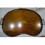 An Edwardian mahogany kidney-shaped two-handled tray with inlaid central shell motif and raised