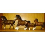 A collection of four Beswick horses: 'Cantering Shire' (brown gloss), 'Shire Foal' (brown gloss), '