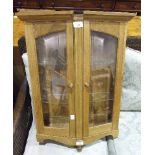 A modern hardwood wall-mounted glazed display cabinet, 67cm high, 48cm wide.