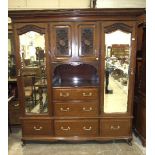 An Edwardian walnut sectional wardrobe by Maple & Co, the cornice above a centre section fitted with