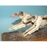 An Austrian painted spelter table-top match strike in the form of two wolfhounds running, the