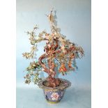 A 20th century Oriental hardstone tree with blossom and fruits, contained in a cloisonné-decorated