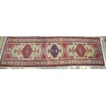A modern Oriental corridor runner with central serrated lozenges on a camel ground, 350cm long,