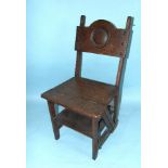 An Edwardian oak metamorphic library chair and steps.