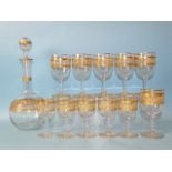 A Victorian gilt-decorated glass decanter with six matching wine glasses and five matching Port