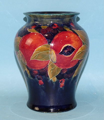 A Moorcroft 'Pomegranate' decorated baluster vase, impressed factory mark and green signature to