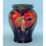 A Moorcroft 'Pomegranate' decorated baluster vase, impressed factory mark and green signature to