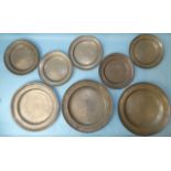 Three large pewter plates with impressed touch marks, 34cm diameter, (one damaged) and five