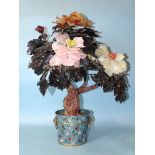 A 20th century Oriental hardstone tree peony contained in a cloisonné-decorated circular pot, 57cm