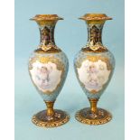 A pair of late-19th century Continental porcelain and champlevé candle holders of baluster form,