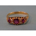 An 18ct gold ruby and diamond ring set three oval rubies with pairs of 8/8-cut diamonds between,