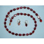 A garnet rivière necklace of thirty-seven uniform oval-cut garnets in 9ct rose gold collet settings,