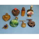 Four small glass scent bottles with ornate metal overlays, an amber scent bottle and two others, (