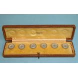 An early-20th century cased set of six mother-of-pearl buttons retailed by Selfridges, London,