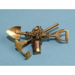 A 9ct yellow gold "gold prospector' brooch formed as a spade, pick, bucket, rope and nuggets, marked