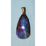 A black opal and diamond pendant claw-set a tear-shaped opal, 28 x 13mm, in unmarked gold mount,