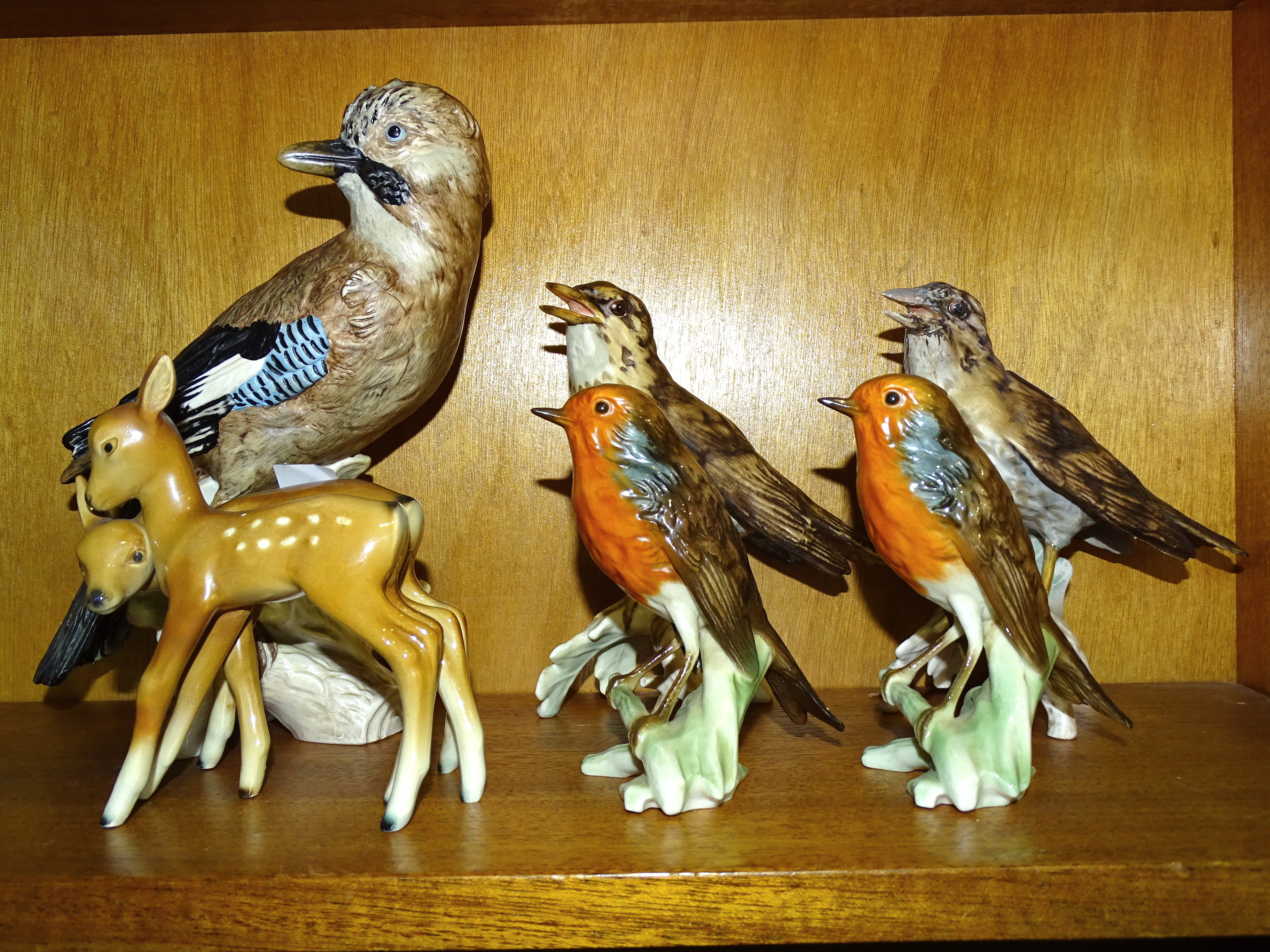 A collection of five Goebel bird ornaments, including a jay, 23.5cm high, two song thrushes 16cm, (