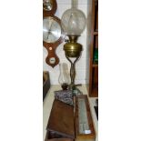 A brass oil lamp on shaped stand with quadruped support, with etched glass globe shade (a/f), 73cm