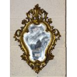 A gilt gesso shaped small wall mirror, 52 x 37cm.